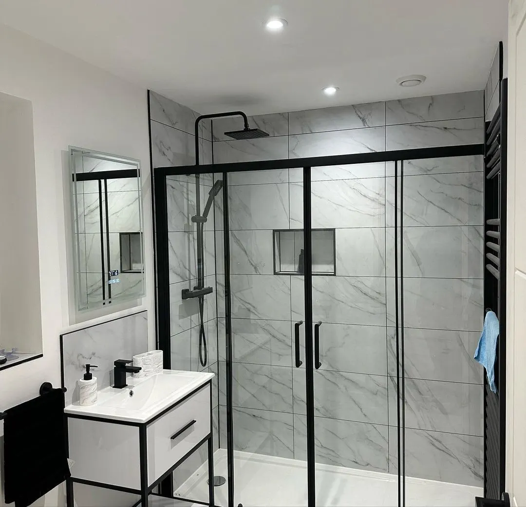 Finished shower room with recessed lights, an extractor and a heated towel rail