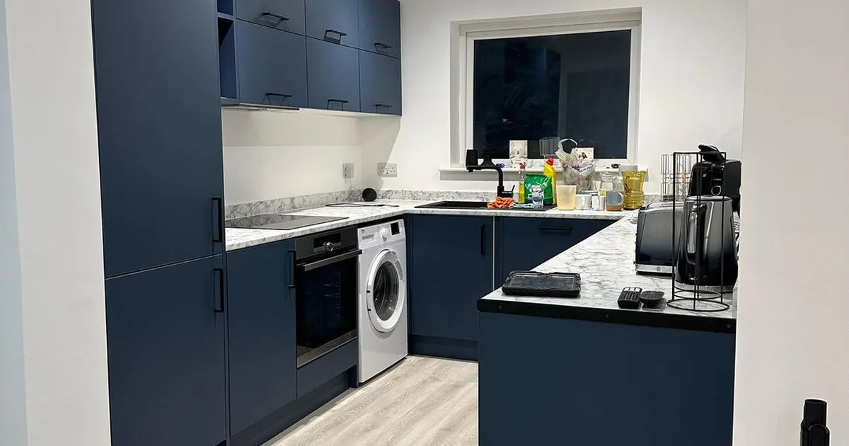 Navy fitted kitchen with downlights and appliance circuits