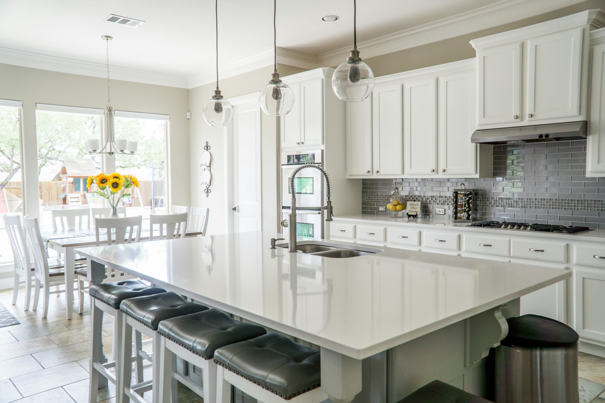 Kitchen Electrical Upgrade White kitchen with pendant lights and breakfast bar seating