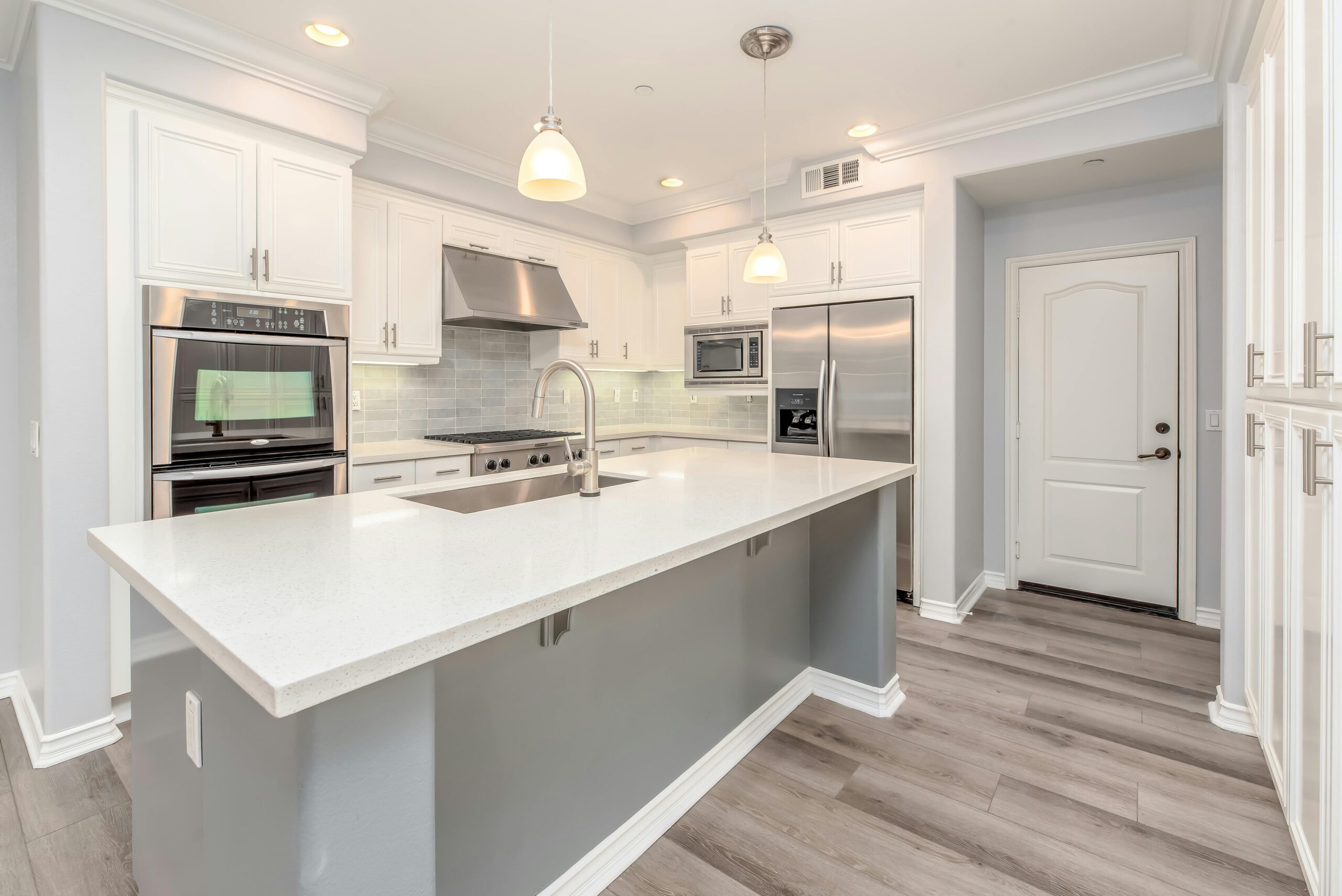 Pendant Light Installation Sleek kitchen with pendant lighting and central island
