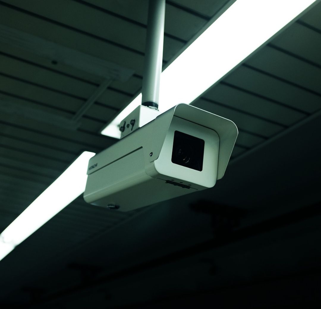 CCTV camera mounted outside a building with data cabling
